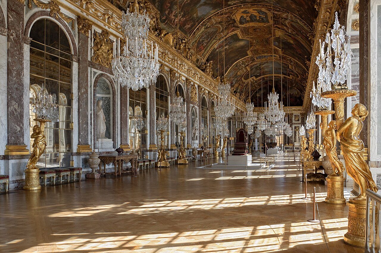 The Hall of Mirrors at the Palace of Versailles, sunlight reflecting off 357 mirrored panels and Le Brun's ceiling paintings